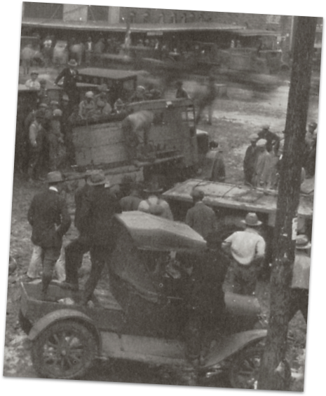 Early cars sinking into mud