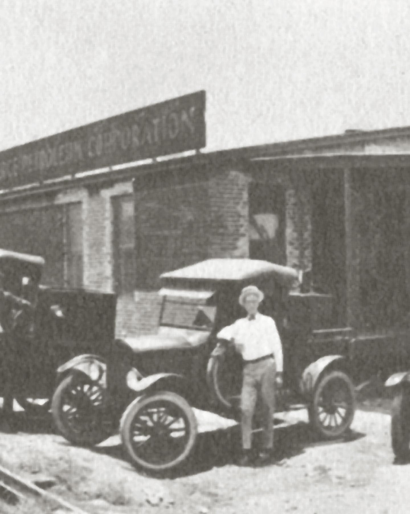 Sinclair salesman in front of car