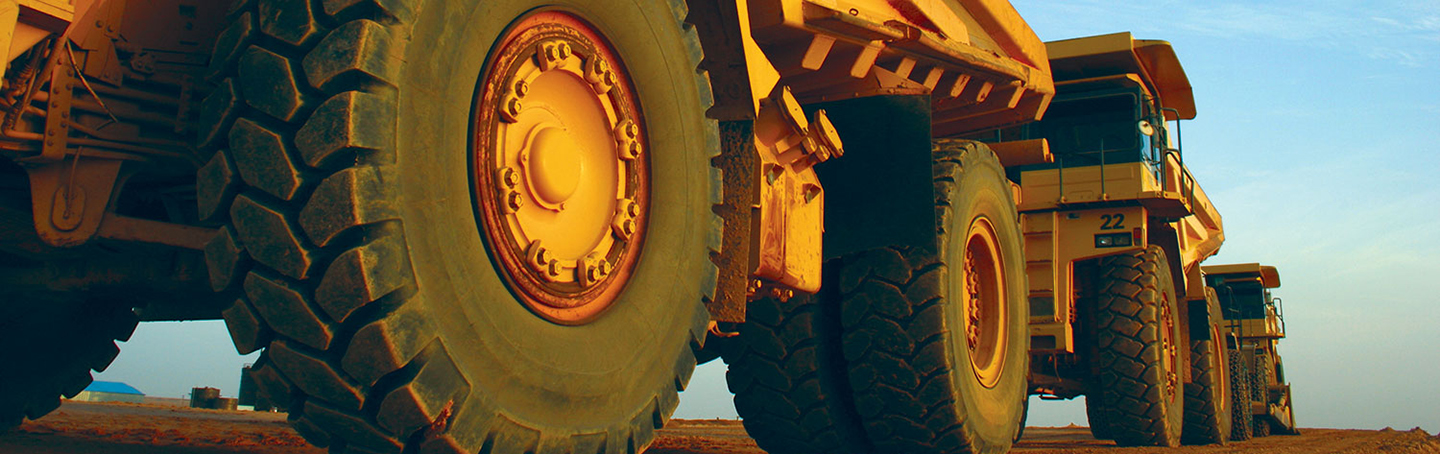 Dump trucks closeup on dirt road