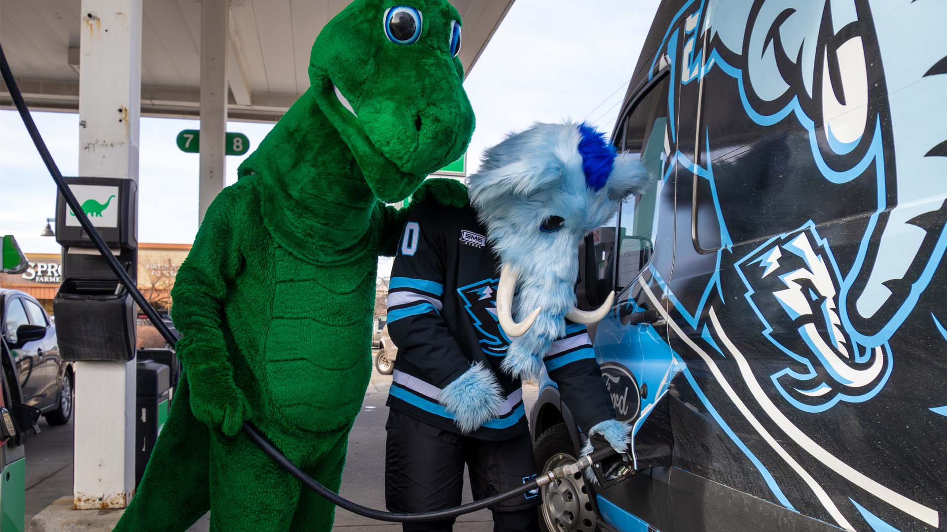 Tusky filling up the truck while Dino Supervises
